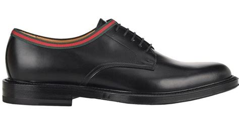 black gucci lace up shoes.